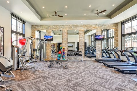 spacious gym with treadmills and weights at the preserve apartments