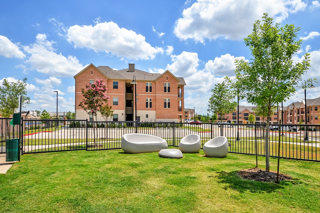 a park with benches in front of a building