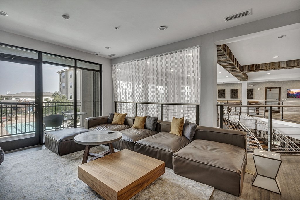 a living room with a leather couch and a coffee table