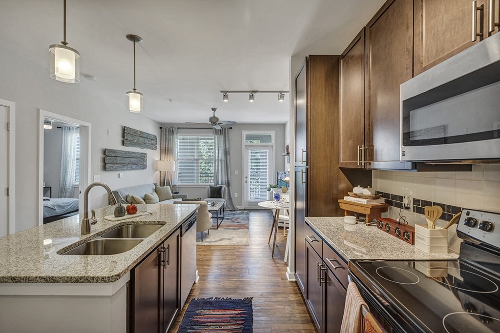 a kitchen and living room with a sink and a counter top