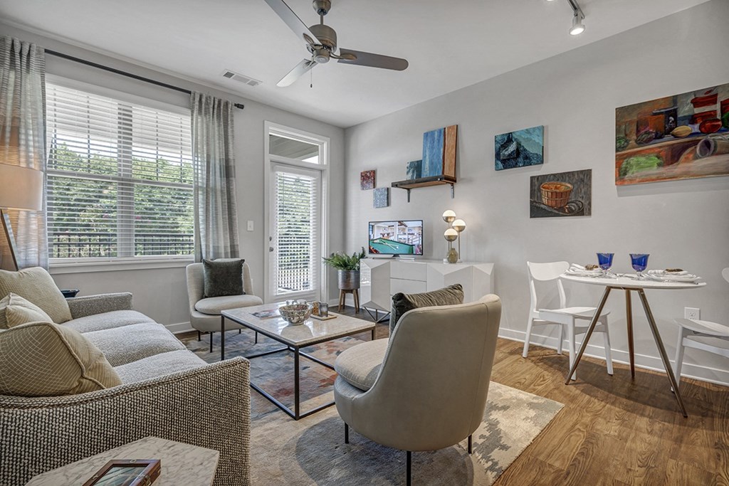 a living room with furniture and a ceiling fan
