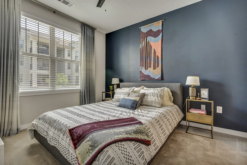 a bedroom with a bed and a painting on the wall