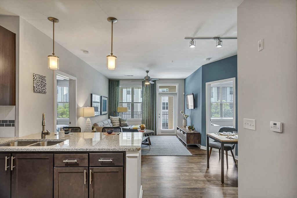 a kitchen and living room with a couch and a table