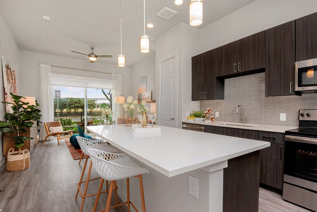 an open kitchen with a large white counter top