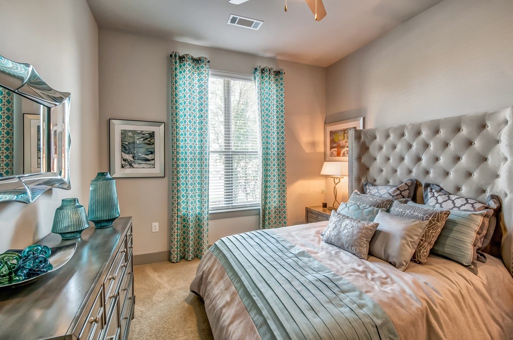 a bedroom with a large bed and a dresser