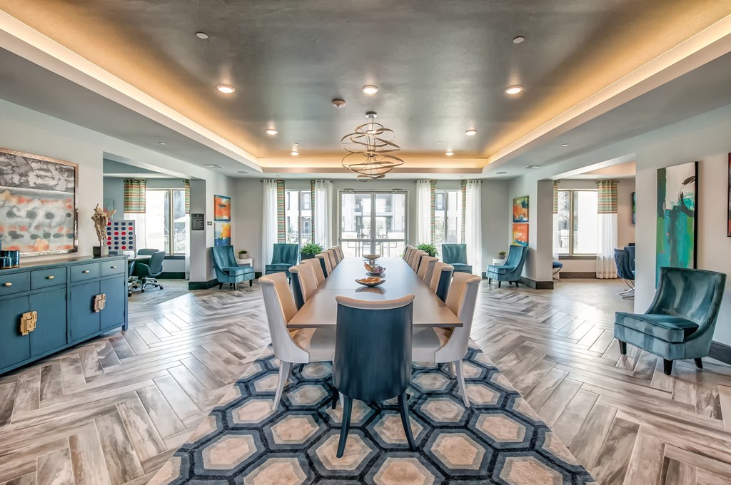 a conference room with a long table and chairs and a chandelier