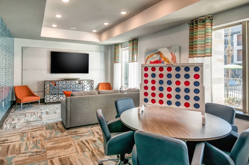 a conference room with a table and chairs and a game board
