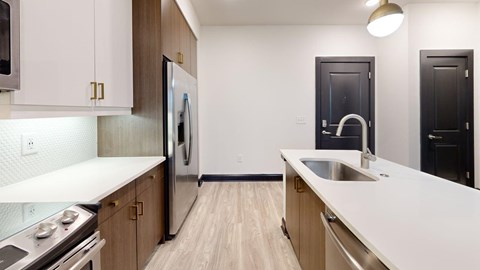 A modern kitchen with wooden cabinets and stainless steel appliances.