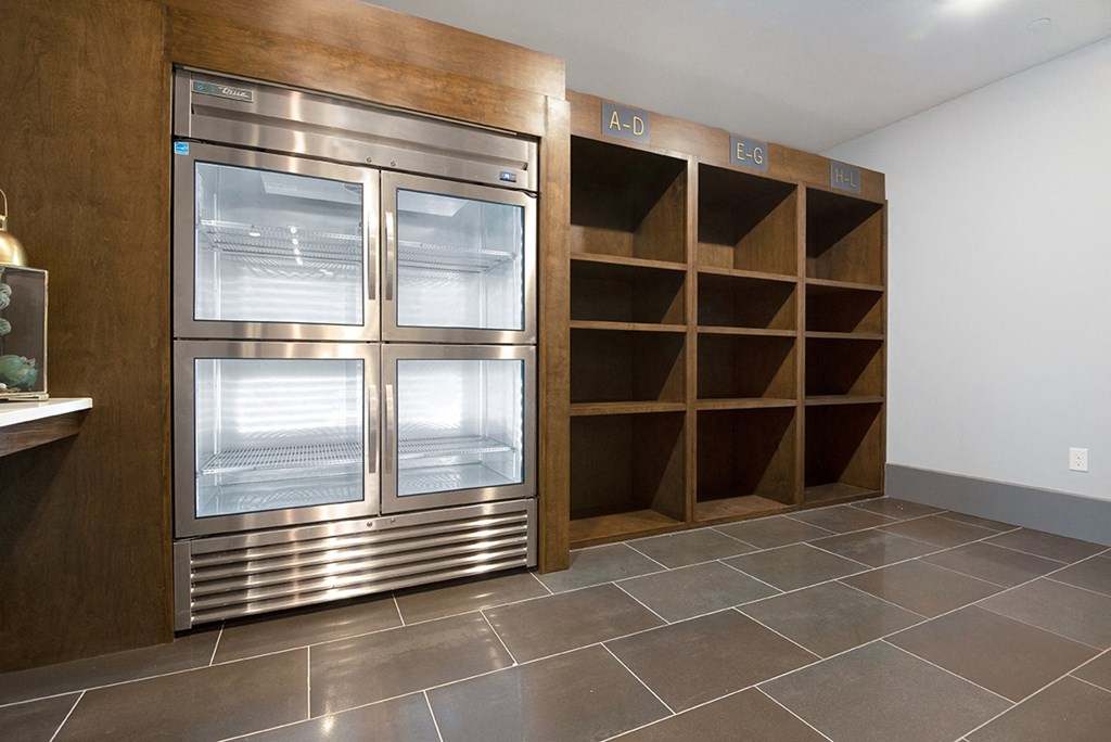 a stainless steel refrigerator and shelves in a kitchen