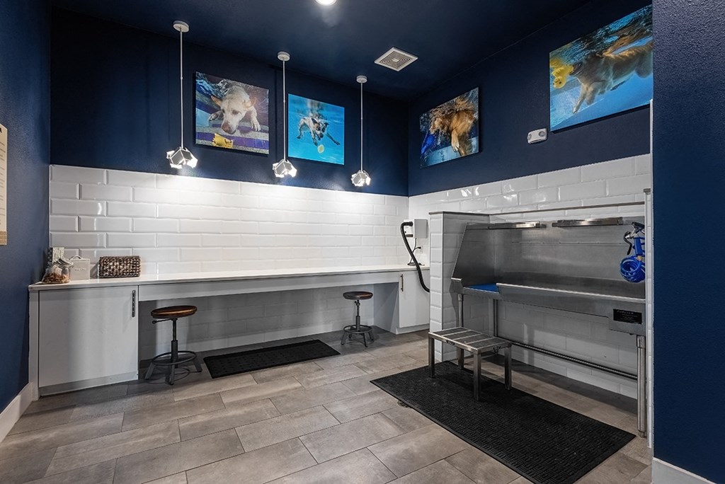a locker room with a sink and a bar with stools