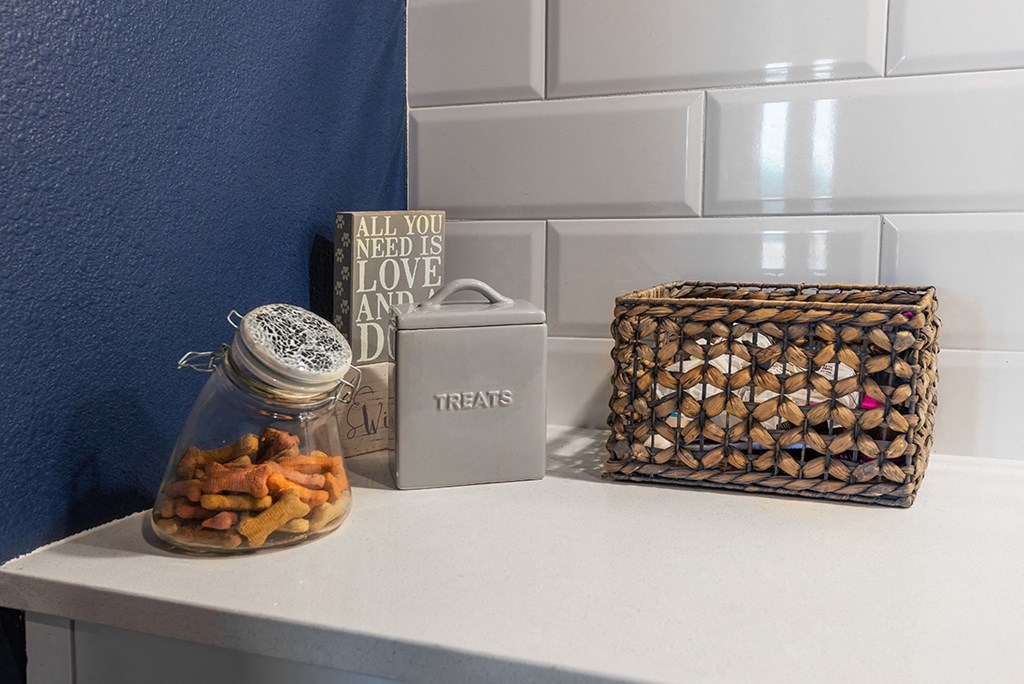 a kitchen counter with a jar of food and a basket