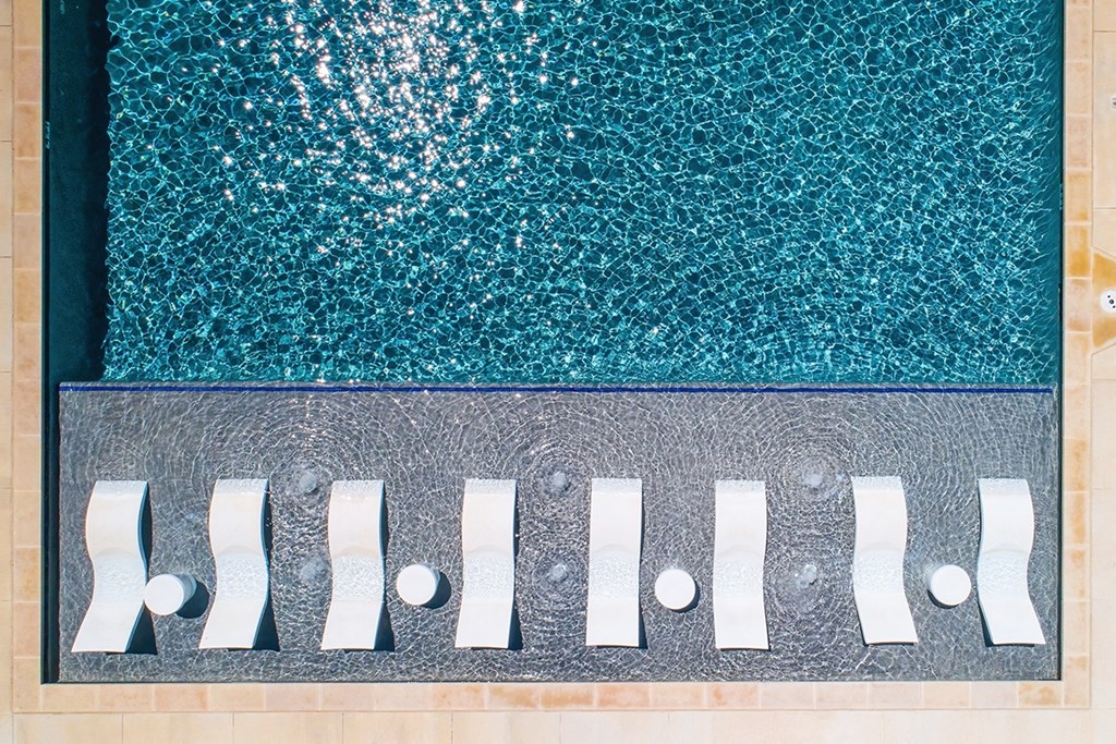 a swimming pool with blue water and a row of white fins