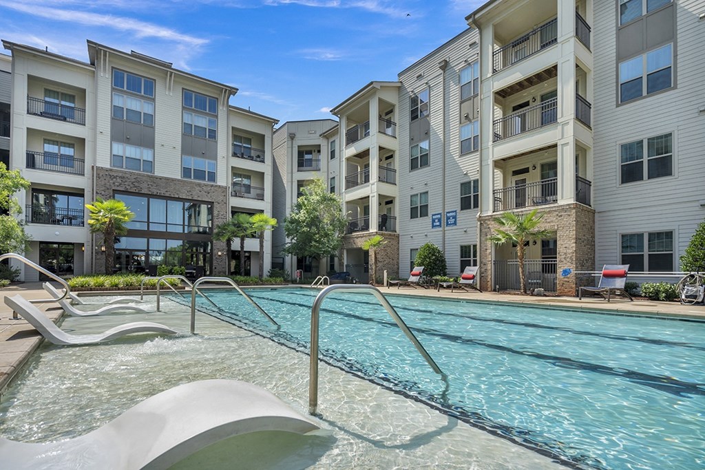 a swimming pool in front of an apartment building