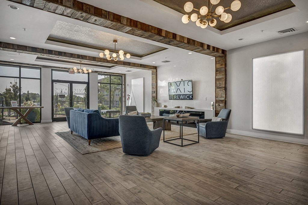 a living room with a table and chairs and a large window