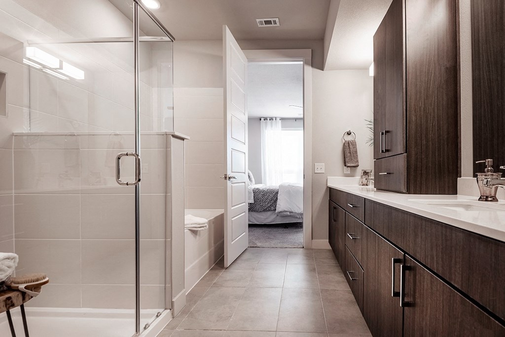 a bathroom with a shower and a sink and a toilet