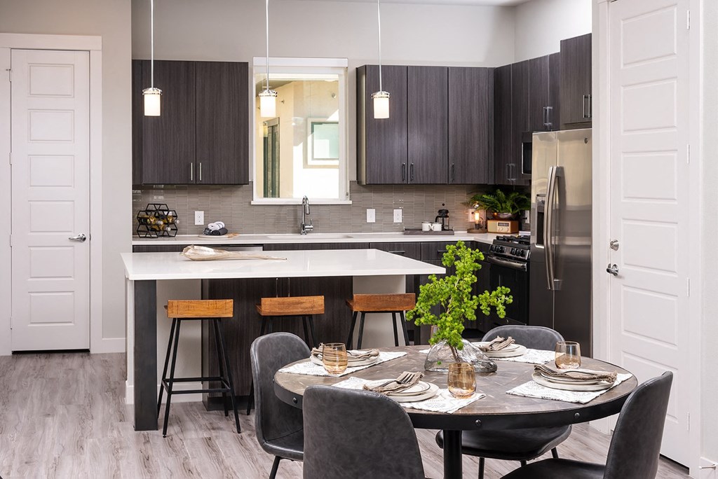 a kitchen and dining room with a table and chairs