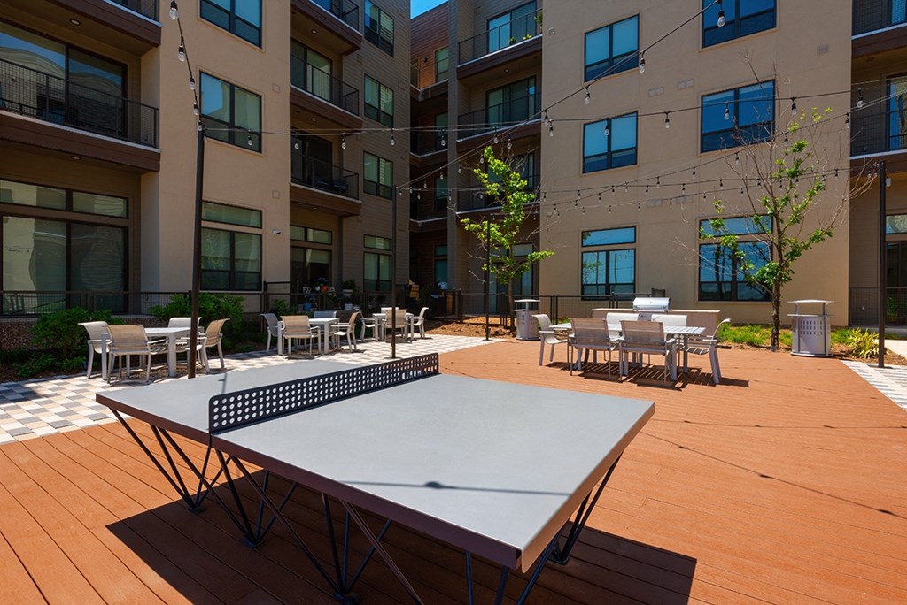 a ping pong table in front of an apartment building