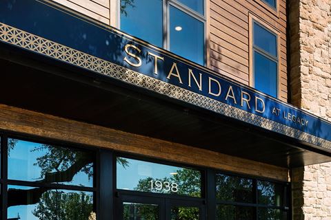 the facade of a building with a sign that reads standard affair