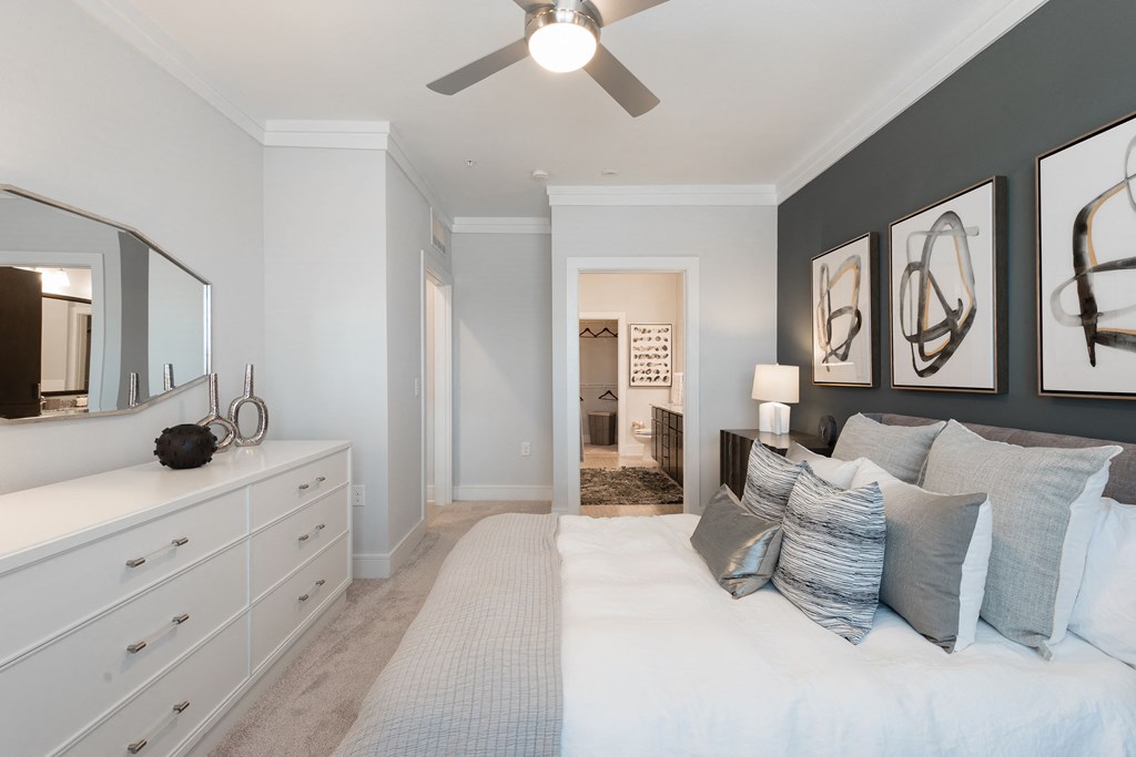 a bedroom with a bed and a ceiling fan