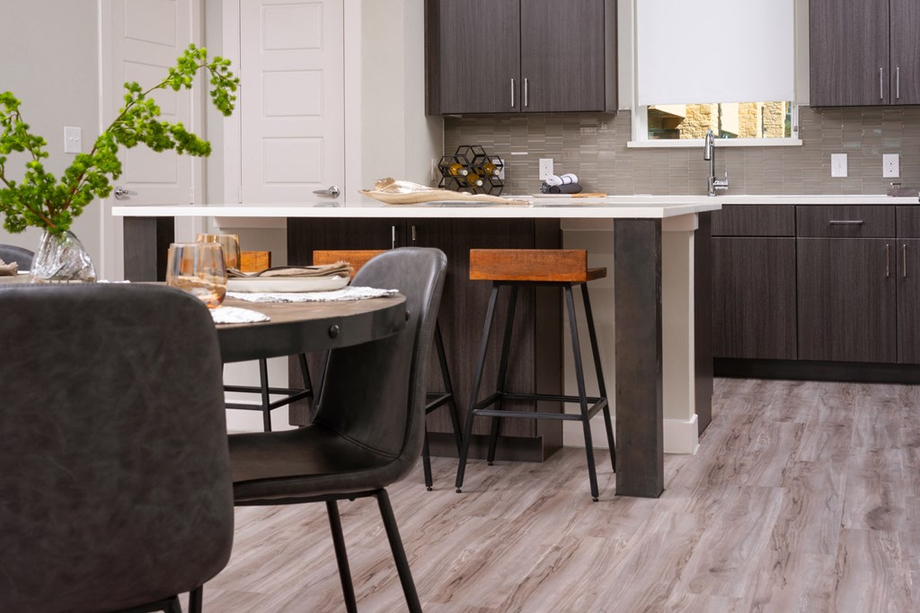 a kitchen and dining area with a table and chairs