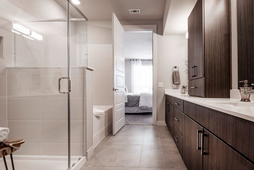 a bathroom with a shower and a sink and a toilet