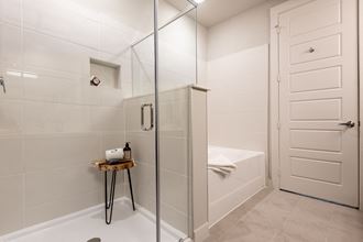 a bathroom with a shower and a tub and a sink