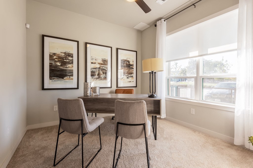 a dining room with a table and chairs and a window