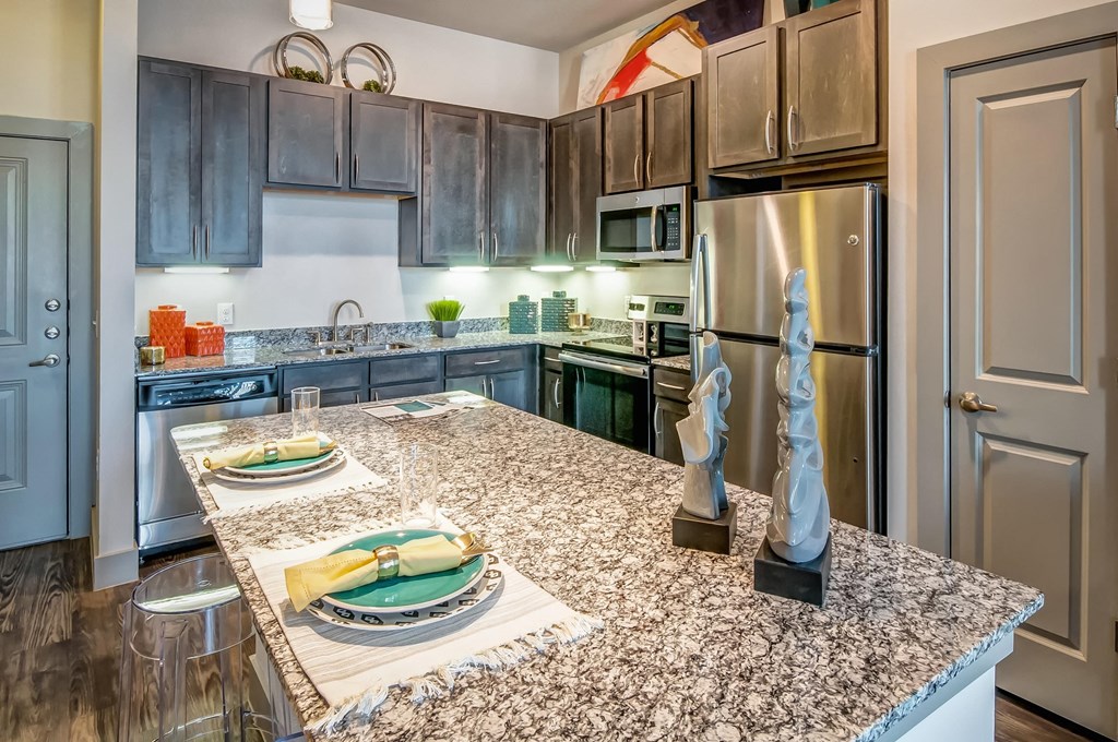 a kitchen with granite counter tops and stainless steel appliances
