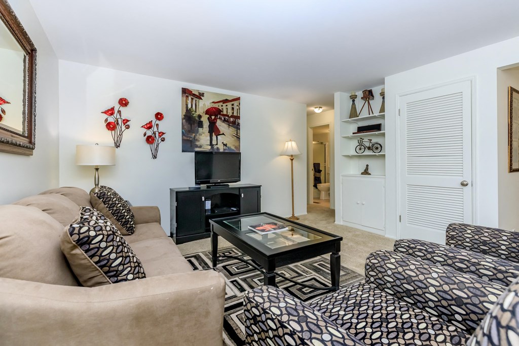 a living room filled with furniture and a flat screen tv