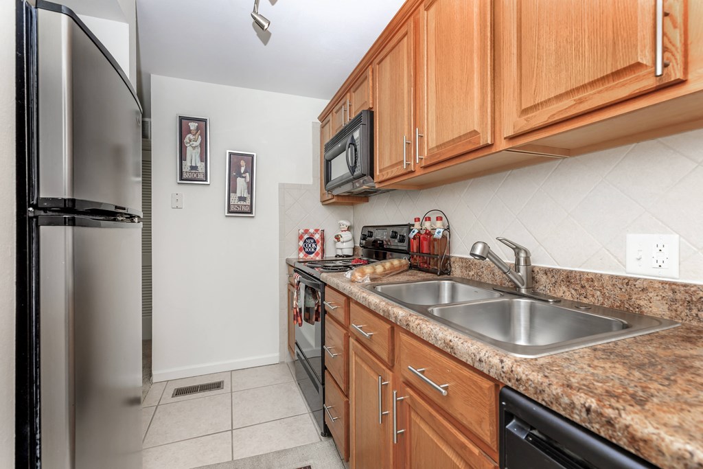 the kitchen has granite countertops and stainless steel appliances
