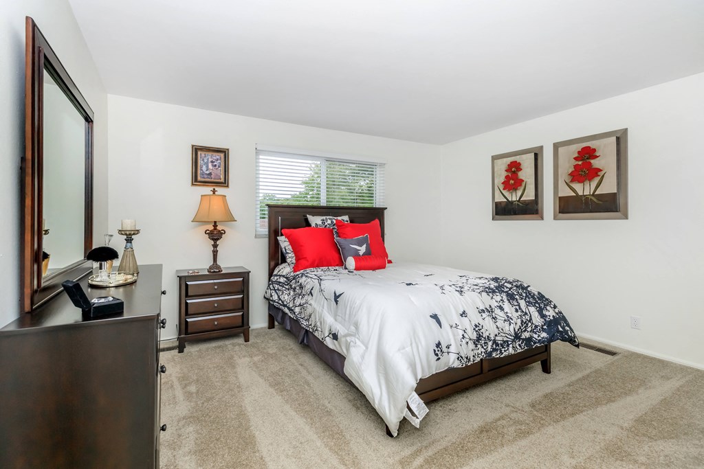 a bedroom with a bed and a dresser