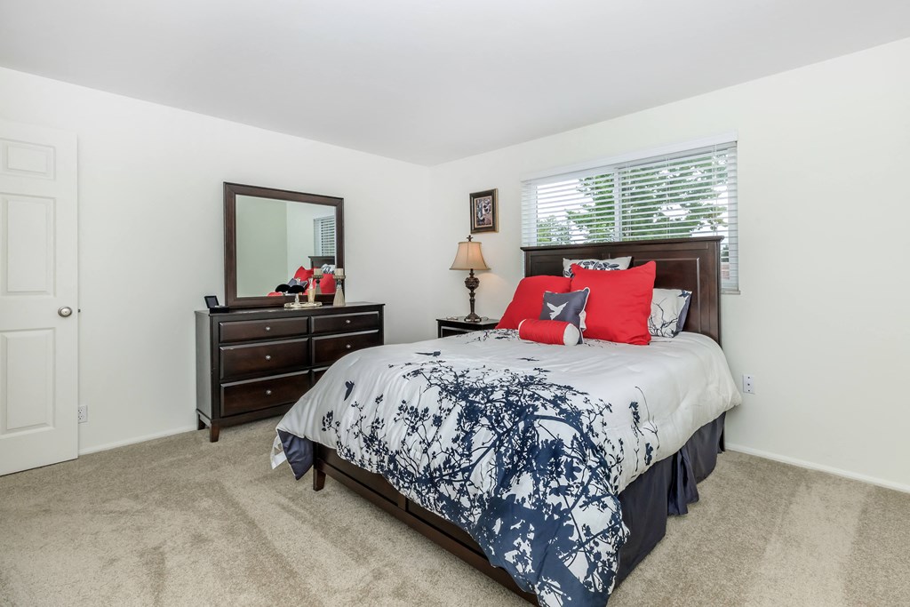 a bedroom with a bed and a dresser