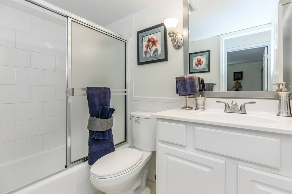 a bathroom with a toilet sink and shower