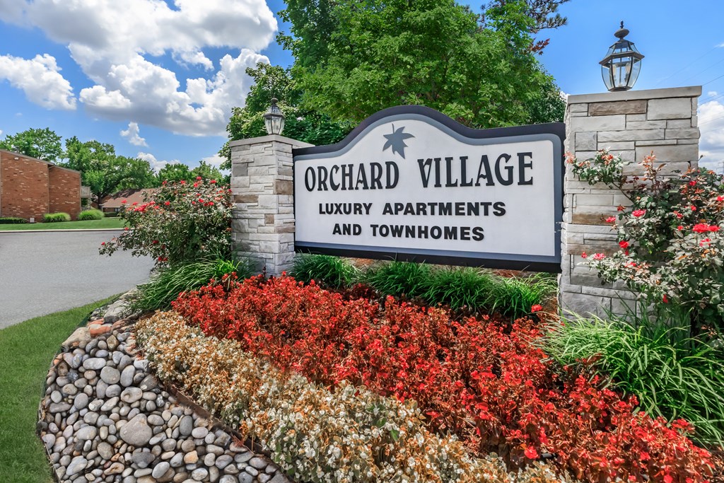 a sign that reads orchard village luxury apartments and townhomes