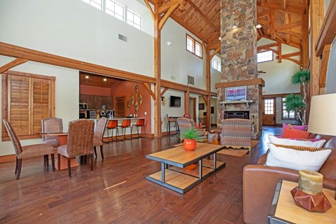 a large living room with a stone fireplace and furniture