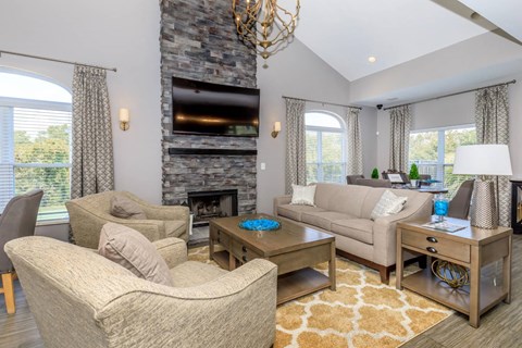 a living room with a couch and chairs and a fireplace