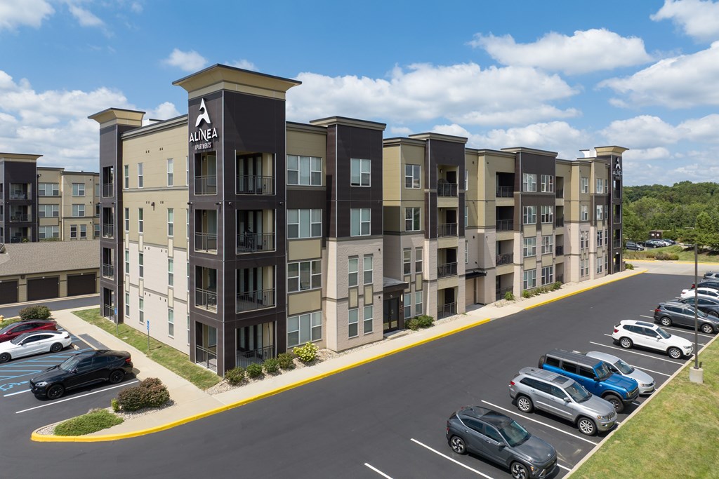 A parking lot in front of apartment buildings.