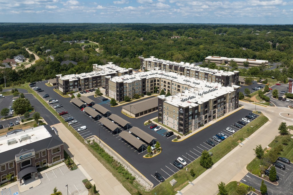 A large building with a parking lot in front of it at Alinea Town and Country Luxury Apartments in Des Peres MO 63131..