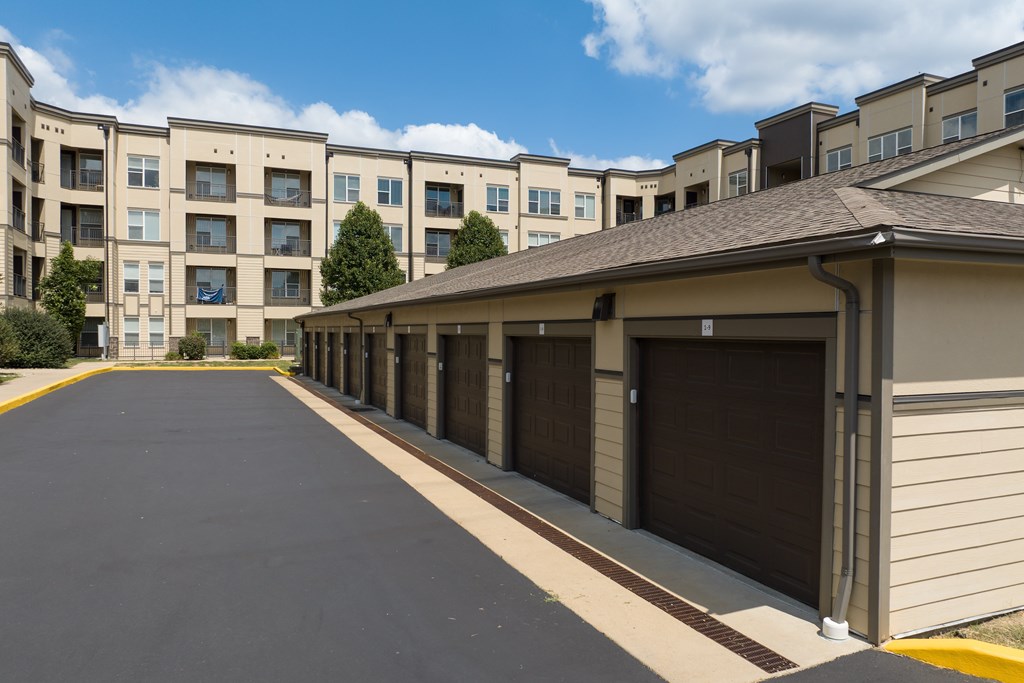 A long row of garage doors in front of apartment buildings at Alinea Town and Country Luxury Apartments in Des Peres MO 63131..