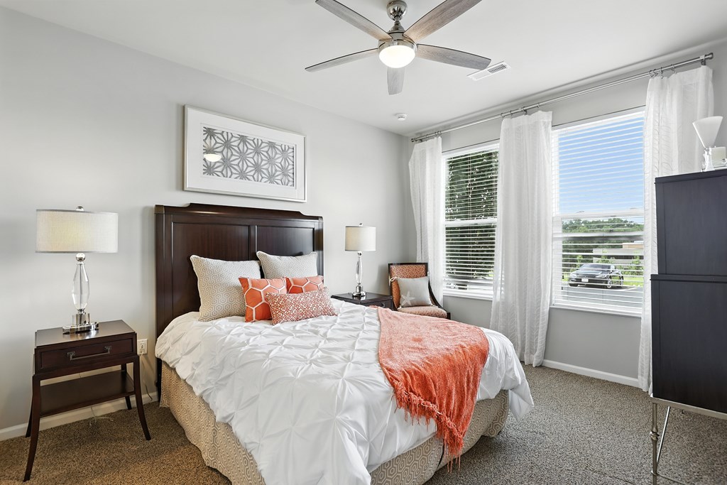 A bedroom with a large bed and a ceiling fan at Alinea Town and Country Luxury Apartments in Des Peres MO 63131..