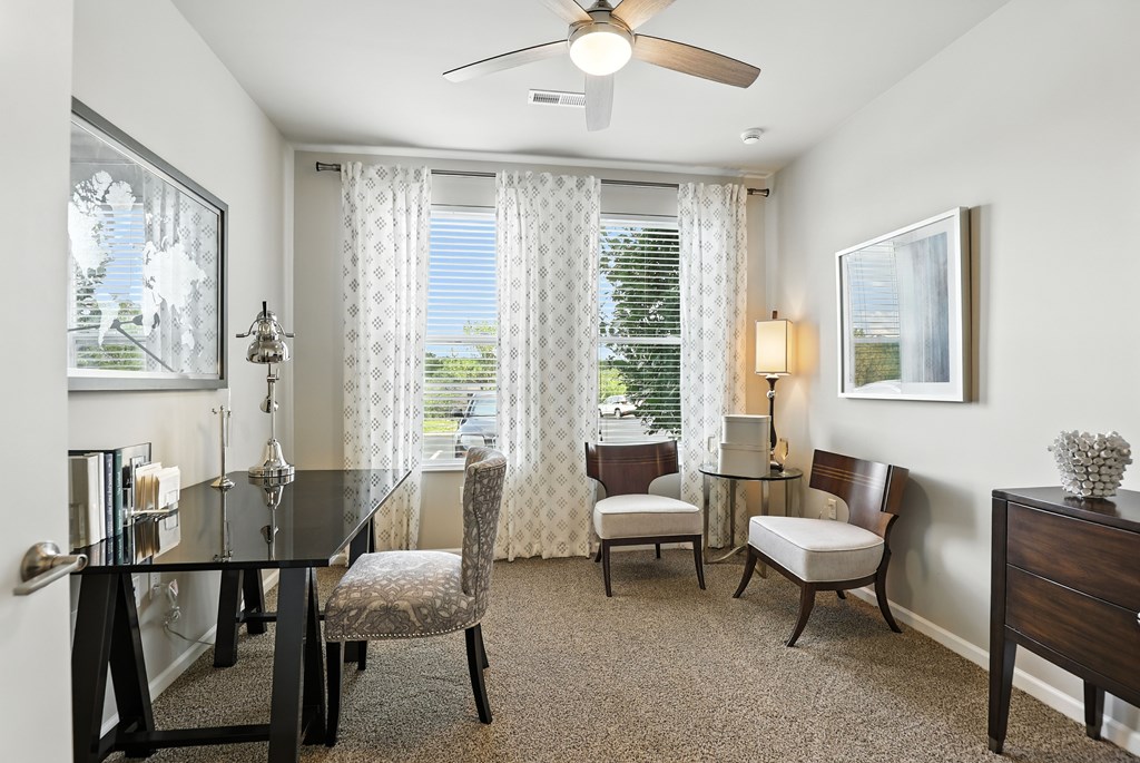 A well-lit dining room with a table set for four at Alinea Town and Country Luxury Apartments in Des Peres MO 63131..