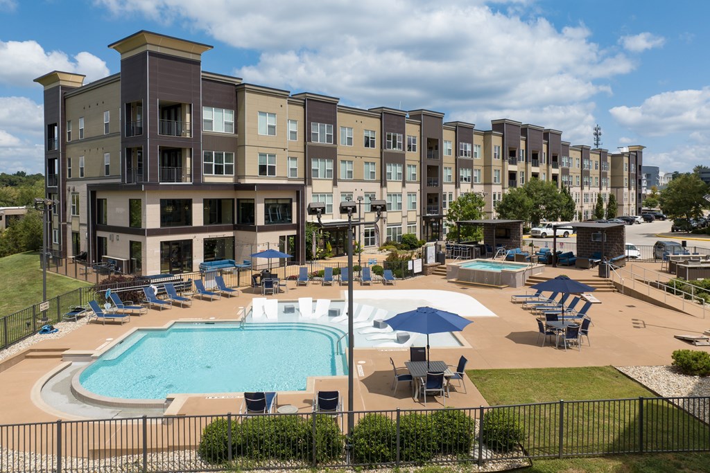 A large apartment complex with a pool and a hot tub at Alinea Town and Country Luxury Apartments in Des Peres MO 63131..