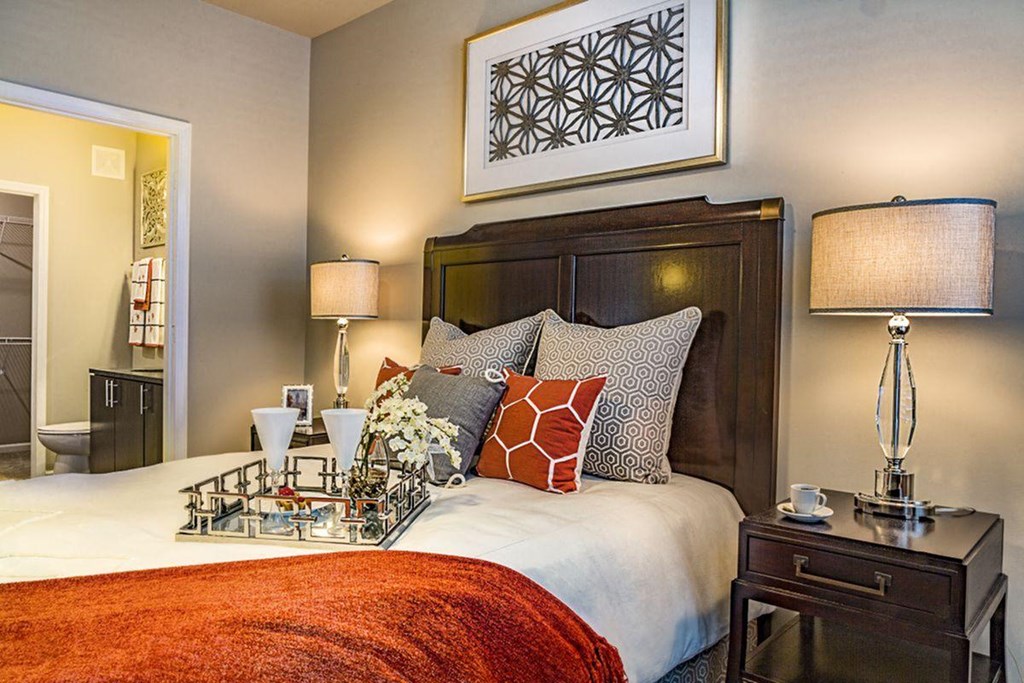 a bedroom with a bed and a table with a nightstand