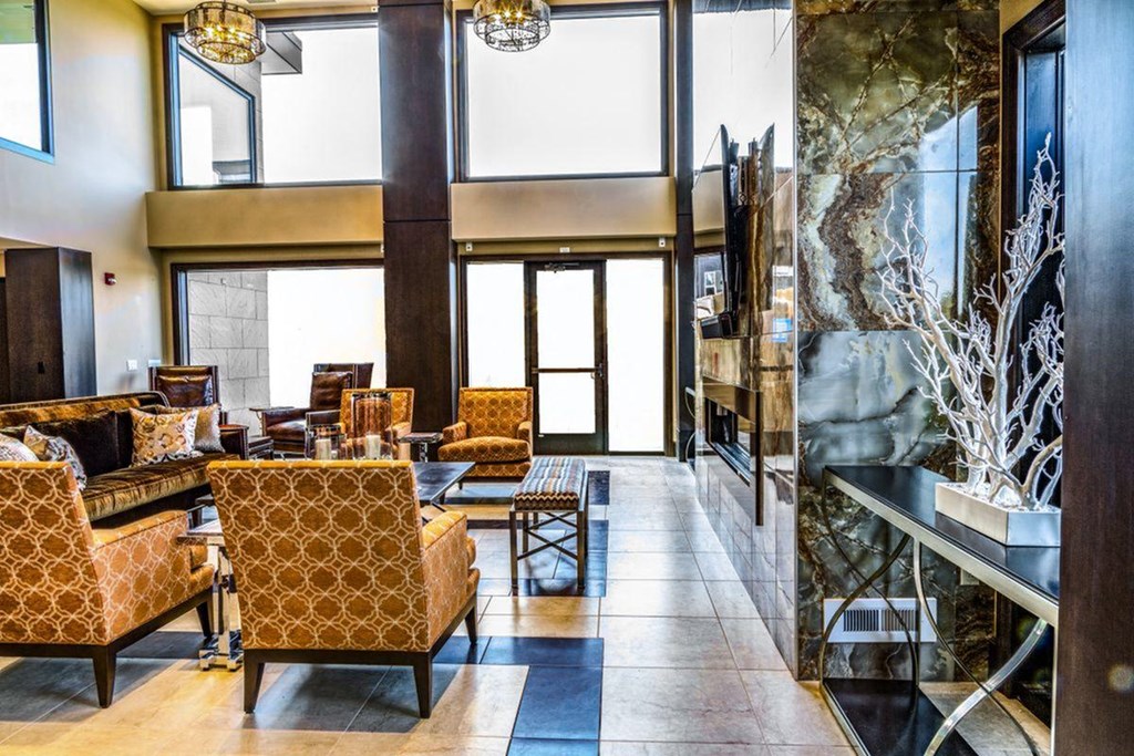 a lobby with couches and chairs and a large window