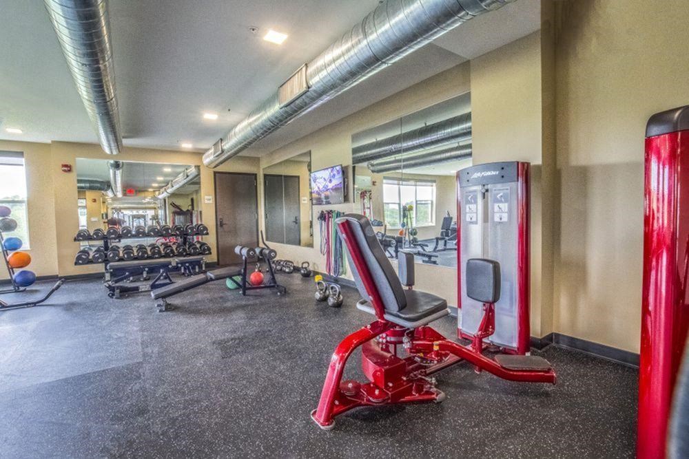 a gym with weights and cardio equipment at the apartments for rent