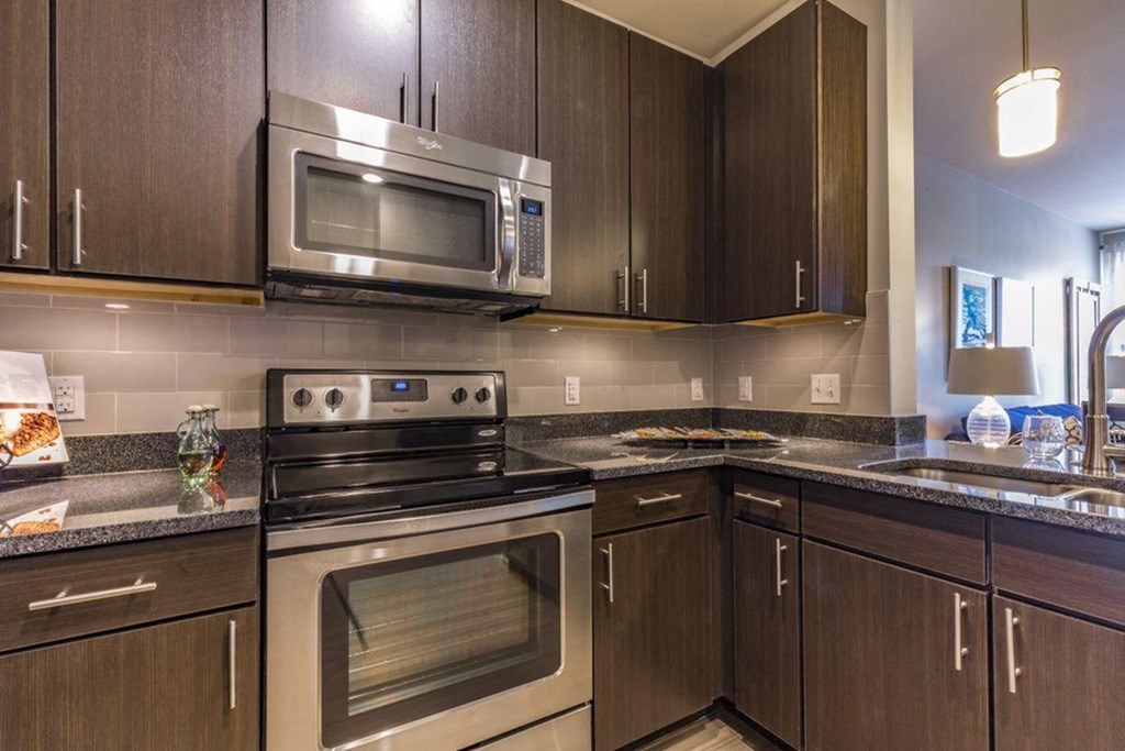 a kitchen with stainless steel appliances and wooden cabinets