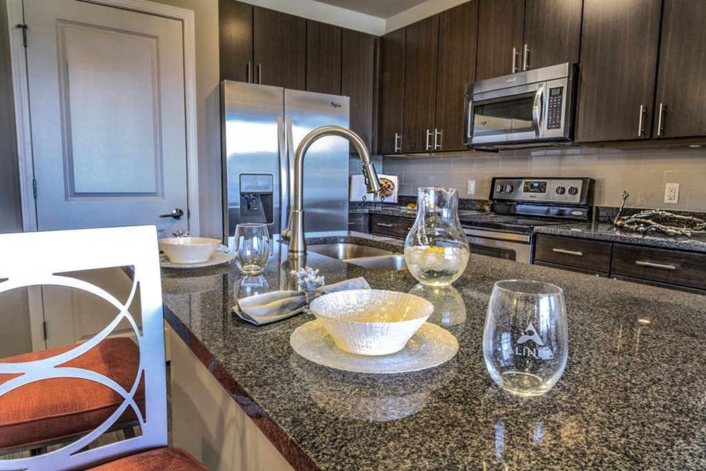 a kitchen with stainless steel appliances and granite counter tops