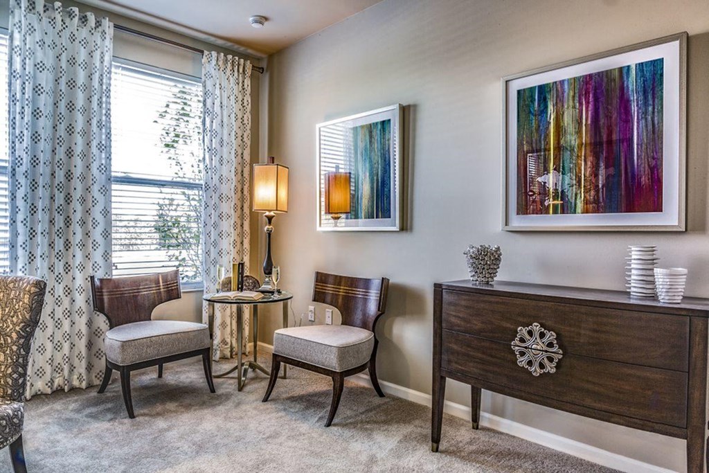 a dining room with two tables and chairs and a window
