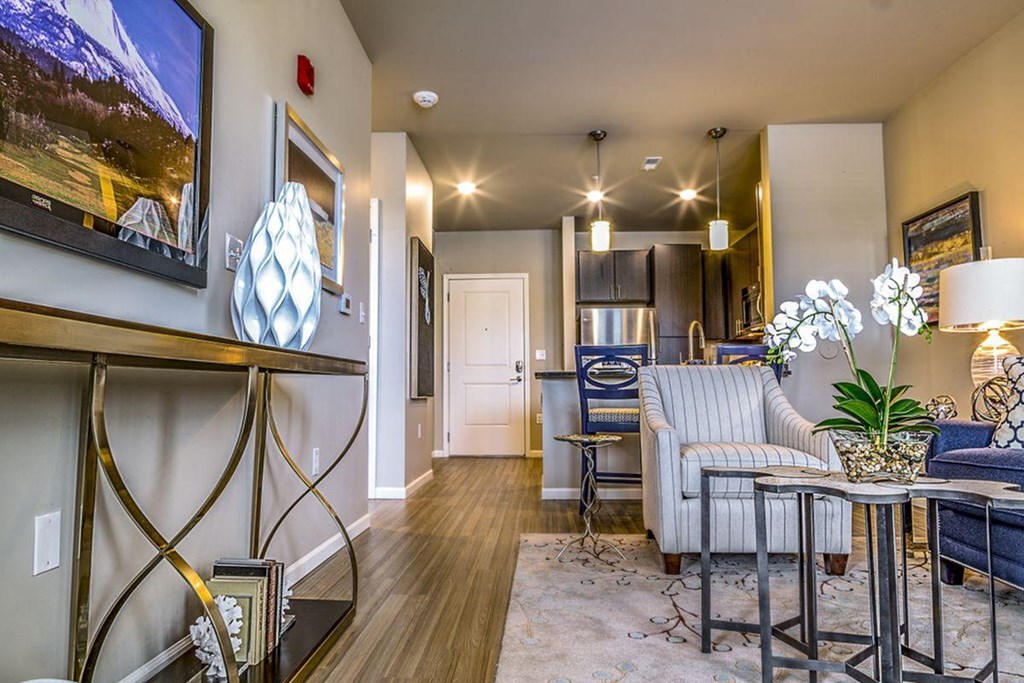 a living room with an armchair and a coffee table