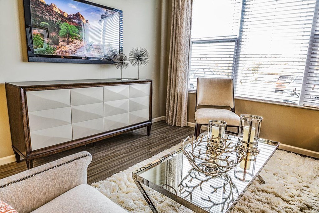 a living room with a glass coffee table and a couch